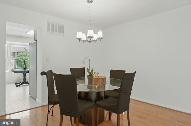 1252 Knoll Mist Ln, Gaithersburg, MD 20879 - dining area with a chandelier and light wood-type flooring