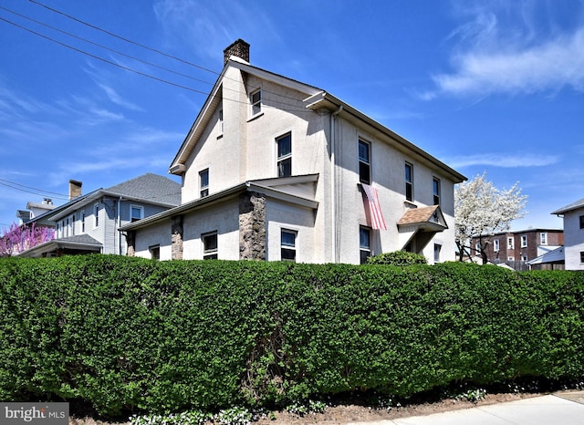 121 Mattison Ave, Ambler, PA 19002 - view of side of property featuring stucco siding, a chimney, and stone siding