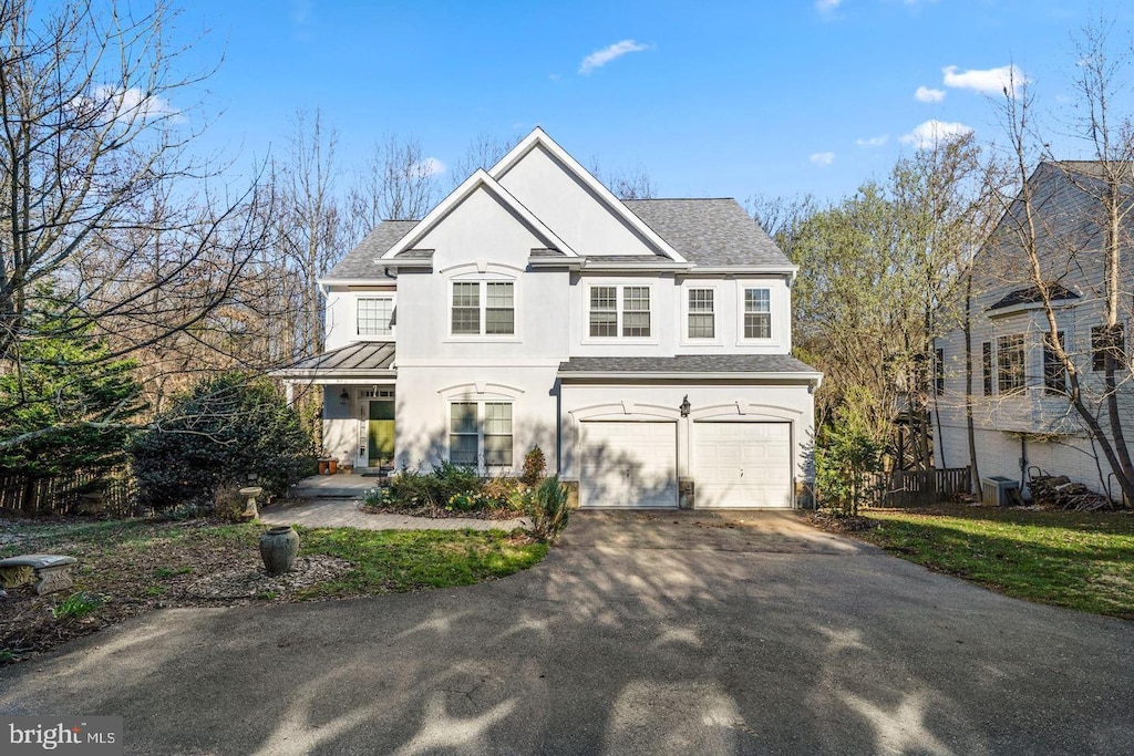 10 Sykes St, Gaithersburg, MD 20877 - view of front of house with asphalt driveway, stucco siding, an attached garage, cooling unit, and roof with shingles