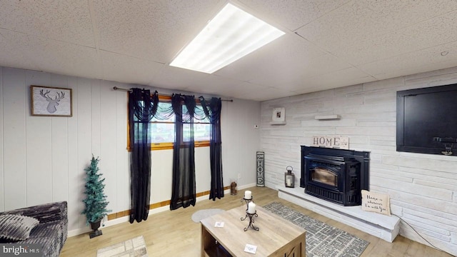 14701 Viewcrest Rd SW, Cresaptown, MD 21502 - living room featuring wood finished floors, a wood stove, a drop ceiling, and baseboards
