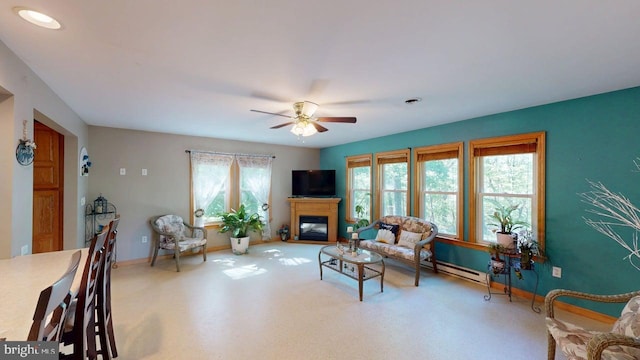 14701 Viewcrest Rd SW, Cresaptown, MD 21502 - living area featuring baseboards, a glass covered fireplace, ceiling fan, carpet floors, and a baseboard heating unit