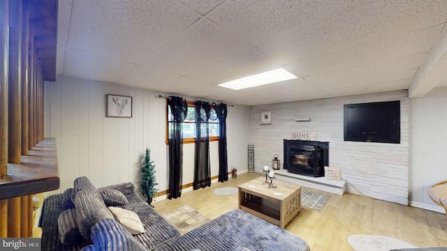 14701 Viewcrest Rd SW, Cresaptown, MD 21502 - living area featuring a wood stove, light wood-style flooring, baseboards, and a drop ceiling