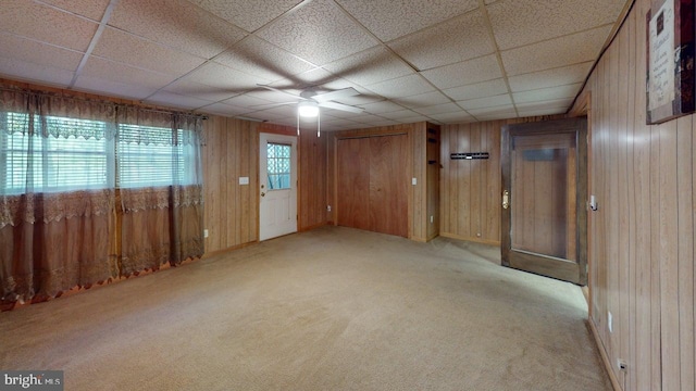 14701 Viewcrest Rd SW, Cresaptown, MD 21502 - spare room with wooden walls, ceiling fan, light colored carpet, and a drop ceiling