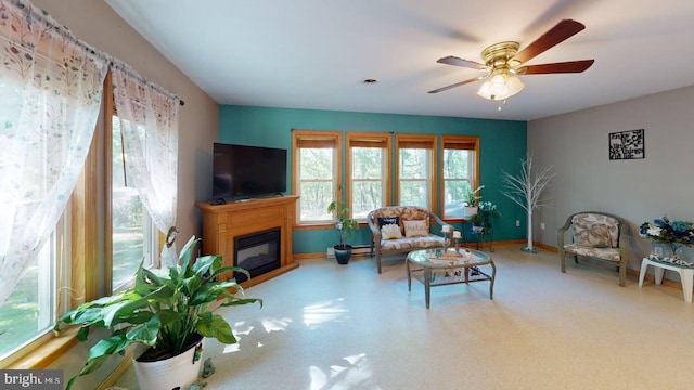14701 Viewcrest Rd SW, Cresaptown, MD 21502 - living area featuring a ceiling fan, a glass covered fireplace, and baseboards