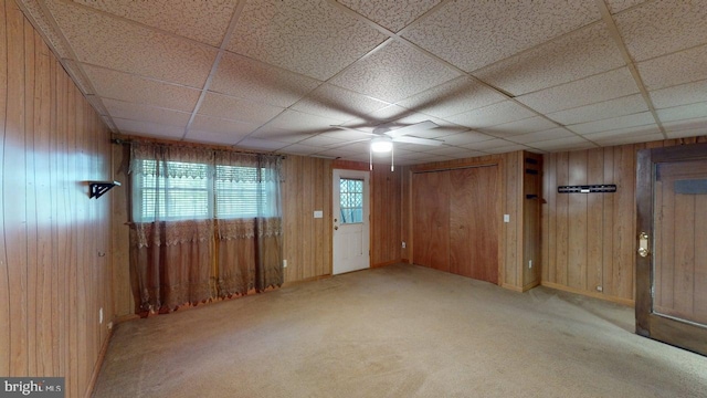 14701 Viewcrest Rd SW, Cresaptown, MD 21502 - empty room with wooden walls, a ceiling fan, carpet flooring, and a drop ceiling