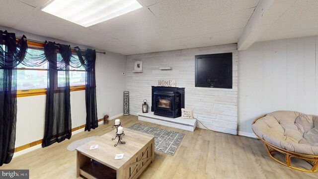 14701 Viewcrest Rd SW, Cresaptown, MD 21502 - living area featuring a wood stove, wood finished floors, baseboards, and a paneled ceiling
