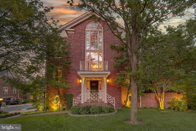 10451 Breckinridge Ln, Fairfax, VA 22030 - view of front of house with a balcony, brick siding, and a lawn