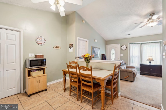 721 Canterbury Dr, Ruther Glen, VA 22546 - dining space with a ceiling fan, light tile patterned flooring, baseboards, high vaulted ceiling, and a textured ceiling