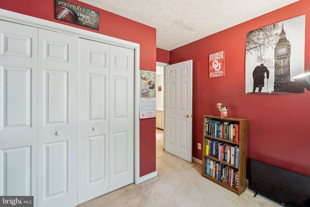 721 Canterbury Dr, Ruther Glen, VA 22546 - bedroom featuring carpet floors, a closet, a textured ceiling, and baseboards