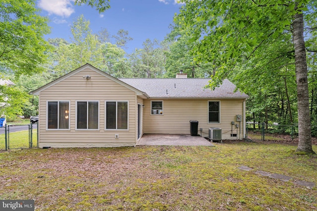 721 Canterbury Dr, Ruther Glen, VA 22546 - back of house with a patio, a chimney, a gate, central air condition unit, and a shingled roof