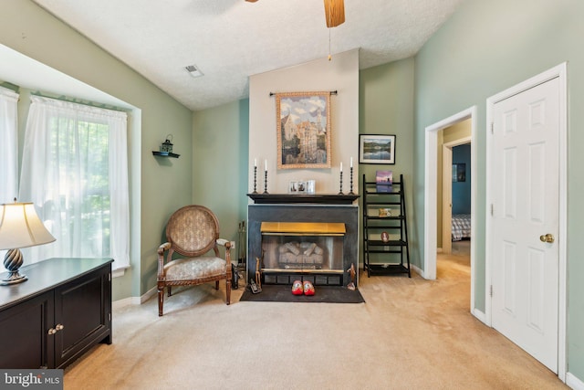 721 Canterbury Dr, Ruther Glen, VA 22546 - living area featuring a glass covered fireplace, light colored carpet, a ceiling fan, baseboards, and vaulted ceiling