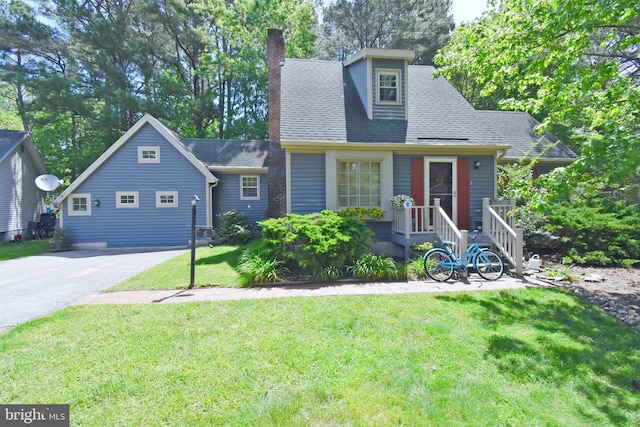 6 Quincy Ct, Ocean Pines, MD 21811 - view of front facade with a chimney, a front lawn, a shingled roof, and driveway
