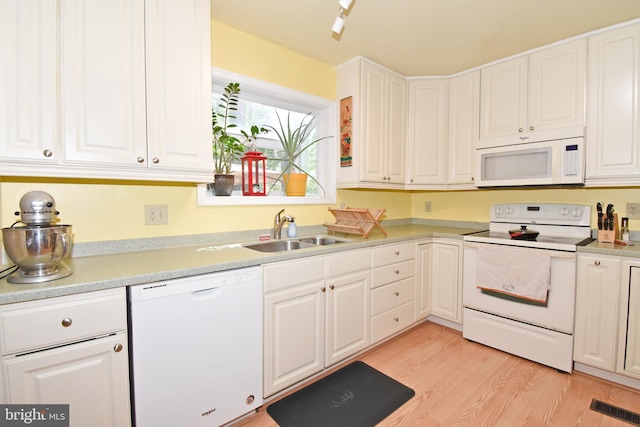 6 Quincy Ct, Ocean Pines, MD 21811 - kitchen featuring white appliances, a sink, white cabinetry, and light wood-style floors