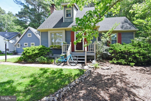 6 Quincy Ct, Ocean Pines, MD 21811 - view of front facade with a chimney, a shingled roof, and a front yard
