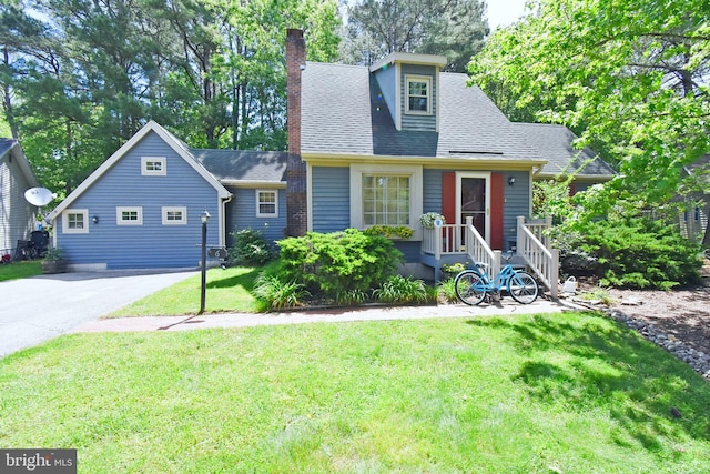 6 Quincy Ct, Ocean Pines, MD 21811 - view of front of home featuring a chimney, a front lawn, a shingled roof, and driveway