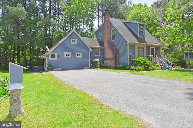 6 Quincy Ct, Ocean Pines, MD 21811 - view of front facade with a chimney, asphalt driveway, a front lawn, and a shingled roof