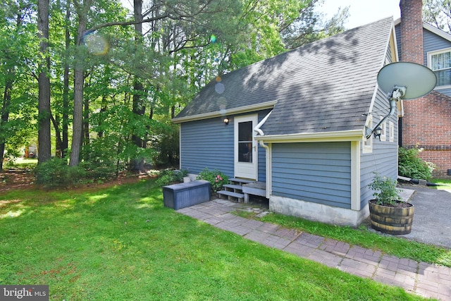 6 Quincy Ct, Ocean Pines, MD 21811 - rear view of property featuring a lawn, roof with shingles, and entry steps