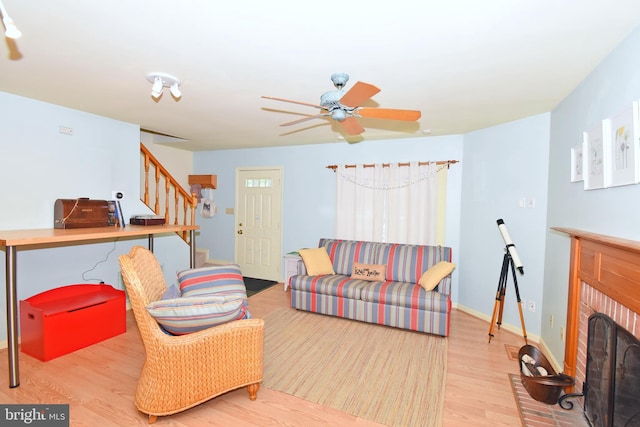 6 Quincy Ct, Ocean Pines, MD 21811 - living room with wood finished floors, a brick fireplace, stairs, ceiling fan, and baseboards