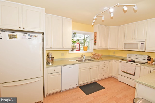 6 Quincy Ct, Ocean Pines, MD 21811 - kitchen with white appliances, a sink, light wood-style flooring, light countertops, and white cabinets