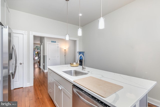 814 N Patterson Park Ave, Baltimore, MD 21205 - kitchen with appliances with stainless steel finishes, a sink, light wood finished floors, and decorative light fixtures