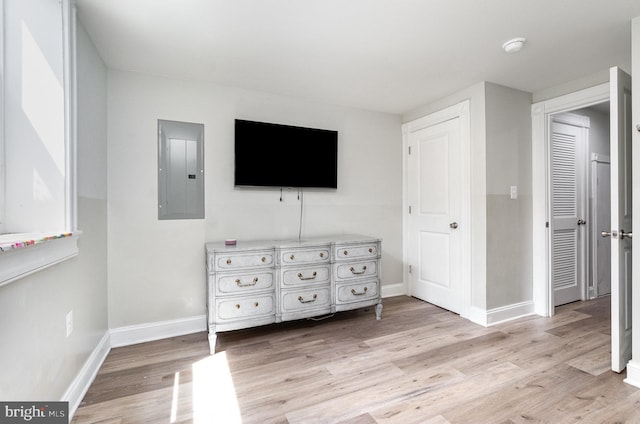 814 N Patterson Park Ave, Baltimore, MD 21205 - bedroom with electric panel, light wood-style flooring, and baseboards