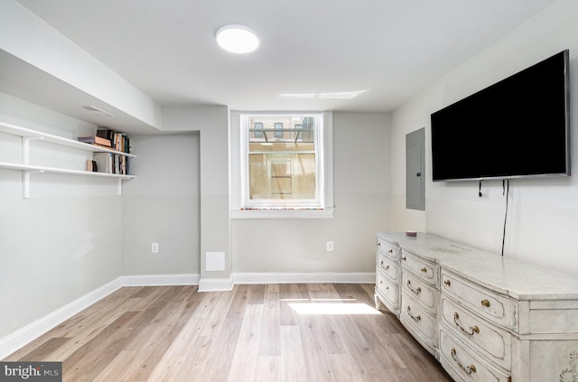 814 N Patterson Park Ave, Baltimore, MD 21205 - unfurnished living room with light wood-style floors, baseboards, and electric panel