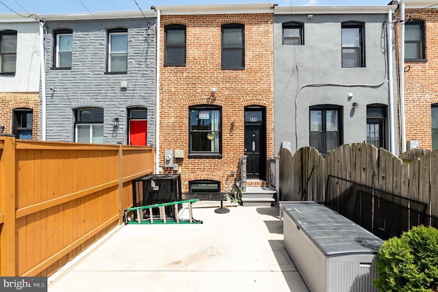 814 N Patterson Park Ave, Baltimore, MD 21205 - view of front of house with brick siding and cooling unit