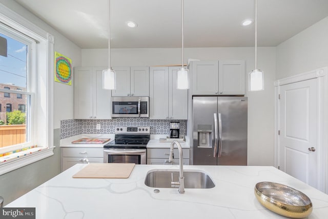 814 N Patterson Park Ave, Baltimore, MD 21205 - kitchen featuring stainless steel appliances, a sink, decorative backsplash, healthy amount of natural light, and recessed lighting