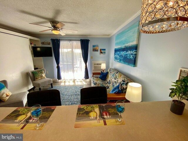 202 32nd St Unit 309, Ocean City, MD 21842 - living room with a textured ceiling, ceiling fan, ornamental molding, and a wall mounted air conditioner