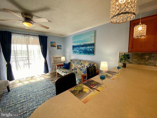 202 32nd St Unit 309, Ocean City, MD 21842 - living area featuring crown molding, a textured ceiling, ceiling fan, an AC wall unit, and a chandelier