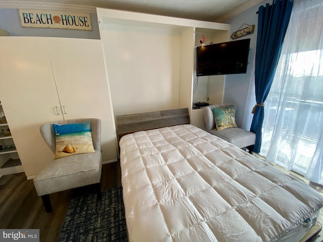 202 32nd St Unit 309, Ocean City, MD 21842 - bedroom featuring wood finished floors and ornamental molding