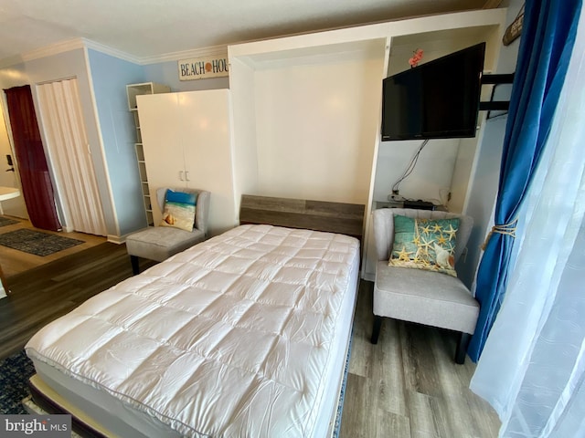 202 32nd St Unit 309, Ocean City, MD 21842 - bedroom featuring wood finished floors and ornamental molding