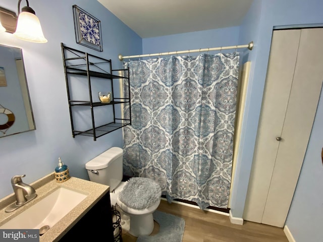 202 32nd St Unit 309, Ocean City, MD 21842 - bathroom featuring wood finished floors, vanity, toilet, curtained shower, and baseboards