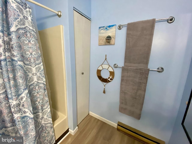 202 32nd St Unit 309, Ocean City, MD 21842 - bathroom with a baseboard heating unit, wood finished floors, shower / bath combo, and baseboards