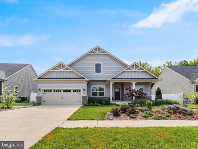 10104 Dressage Dr, Upper Marlboro, MD 20772 - craftsman-style home with an attached garage, concrete driveway, stone siding, cooling unit, and board and batten siding