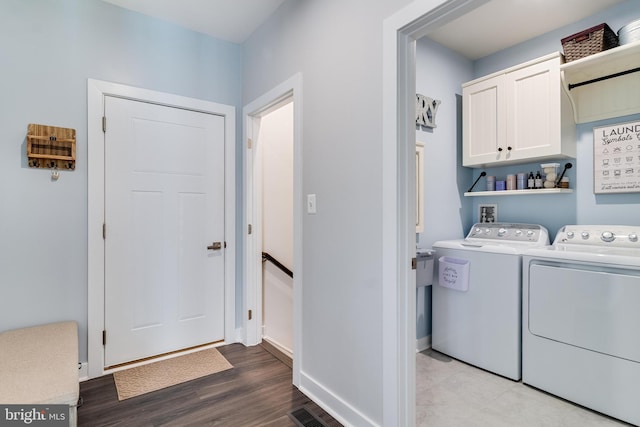 10104 Dressage Dr, Upper Marlboro, MD 20772 - laundry room with cabinet space, washing machine and dryer, wood finished floors, and baseboards