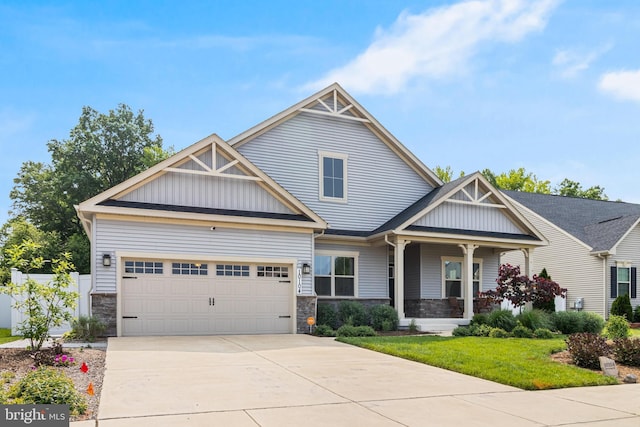 10104 Dressage Dr, Upper Marlboro, MD 20772 - craftsman inspired home with stone siding, an attached garage, driveway, and covered porch