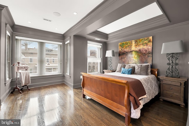 bedroom with crown molding, wood finished floors, and baseboards