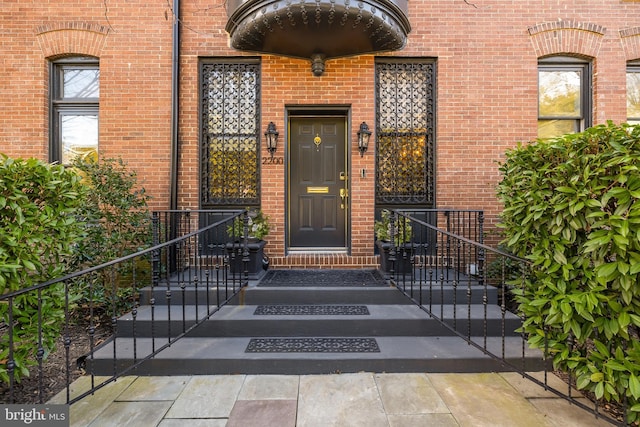 property entrance with brick siding
