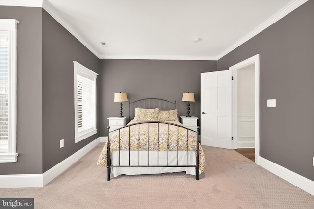bedroom featuring carpet flooring, crown molding, and baseboards