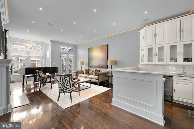 living room with ornamental molding, healthy amount of natural light, and dark wood finished floors