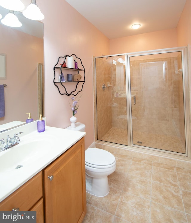 301 Muir St Unit 201, Cambridge, MD 21613 - full bath featuring a stall shower, toilet, tile patterned flooring, and vanity