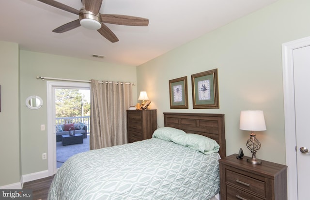 301 Muir St Unit 201, Cambridge, MD 21613 - bedroom featuring access to outside, dark wood-style flooring, baseboards, and a ceiling fan