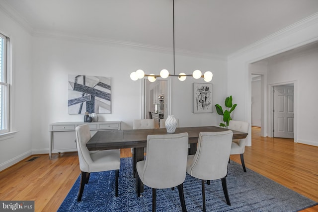 5127 Cathedral Ave NW, Washington, DC 20016 - dining room featuring crown molding, light wood-type flooring, healthy amount of natural light, and baseboards
