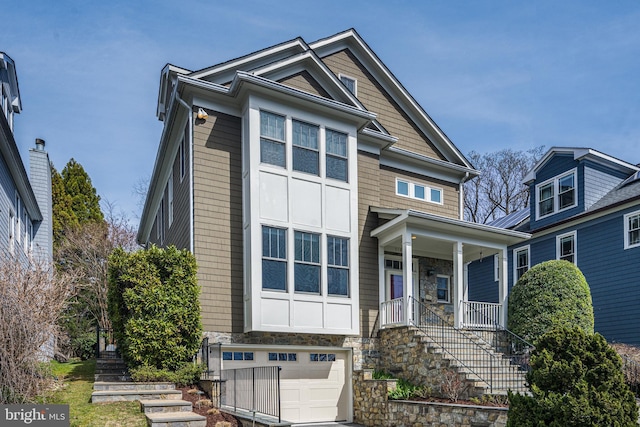 5127 Cathedral Ave NW, Washington, DC 20016 - view of front of house featuring stairway, covered porch, stone siding, and an attached garage