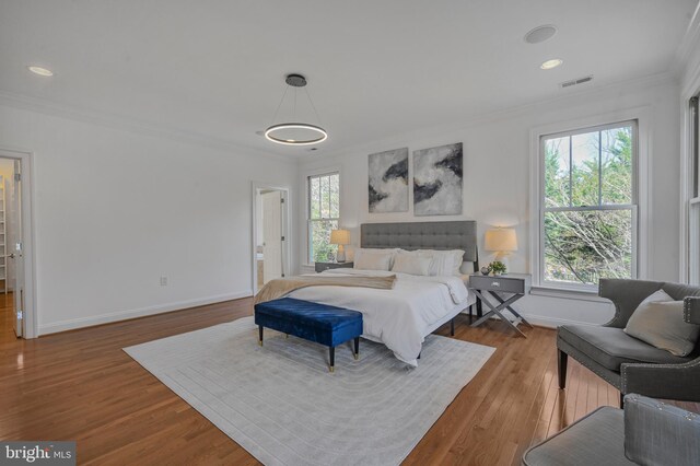 5127 Cathedral Ave NW, Washington, DC 20016 - bedroom with ornamental molding, baseboards, wood finished floors, and recessed lighting