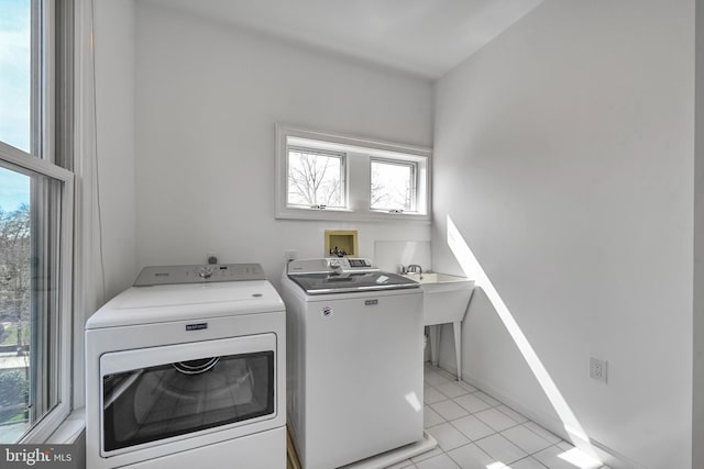 5127 Cathedral Ave NW, Washington, DC 20016 - laundry area featuring separate washer and dryer and light tile patterned floors