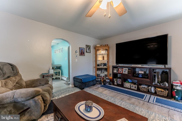 46 Jefferson St, Weatherly, PA 18255 - living room featuring arched walkways, wood finished floors, a ceiling fan, and a baseboard radiator