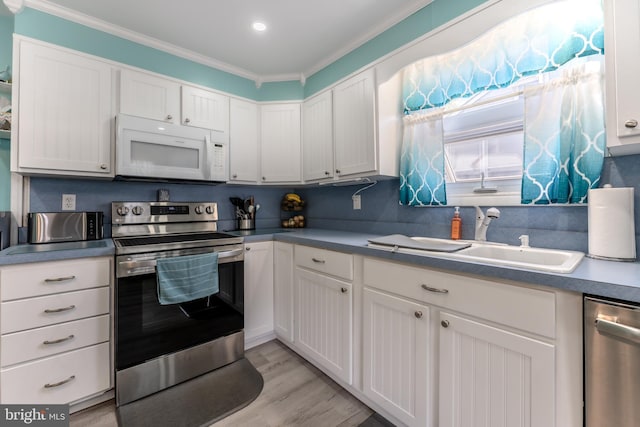46 Jefferson St, Weatherly, PA 18255 - kitchen featuring stainless steel appliances, a sink, crown molding, white cabinetry, and light wood finished floors
