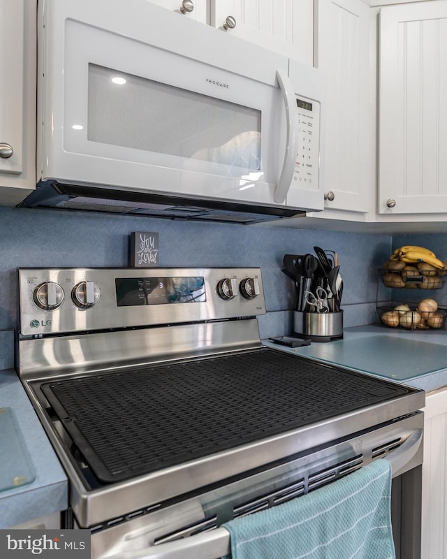 46 Jefferson St, Weatherly, PA 18255 - kitchen view of white microwave, stainless steel range with electric stovetop, and white cabinetry